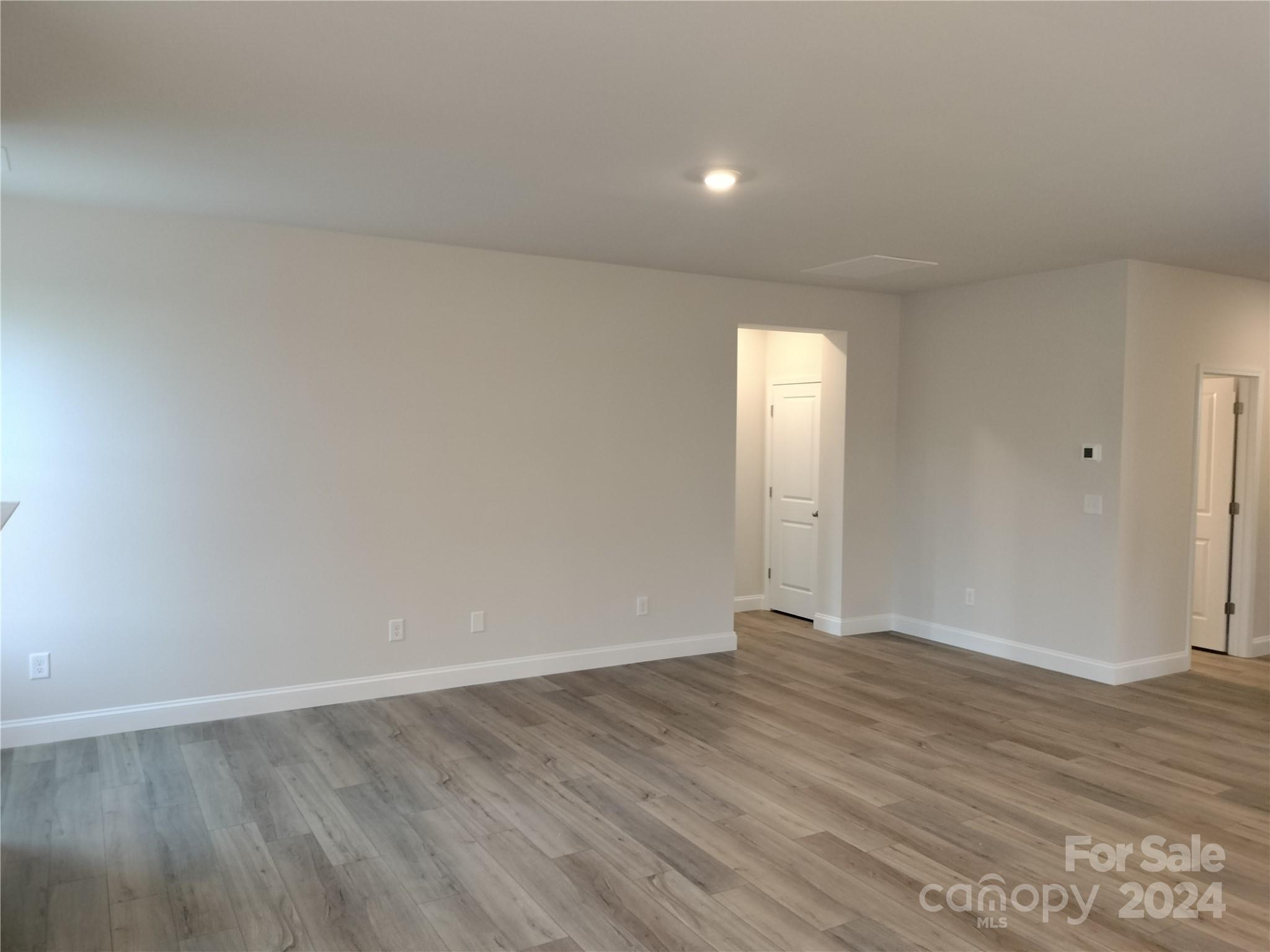 252 Hamrick Road, Unit 10 Cramerton, NC 28056 - Photo 12 of 37 a view of an empty room with wooden floor and a window