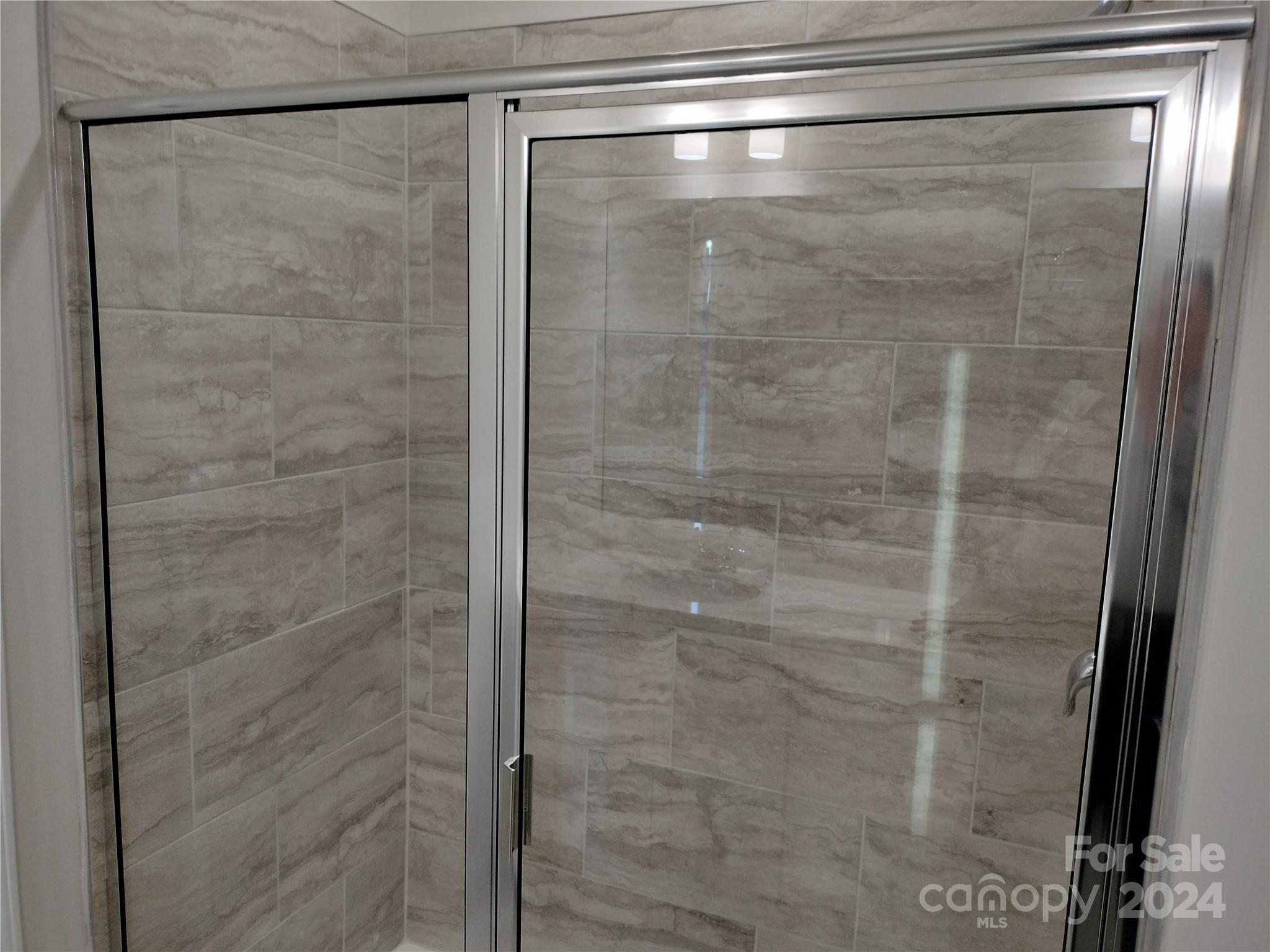 252 Hamrick Road, Unit 10 Cramerton, NC 28056 - Photo 22 of 37 a bathroom with a glass shower door