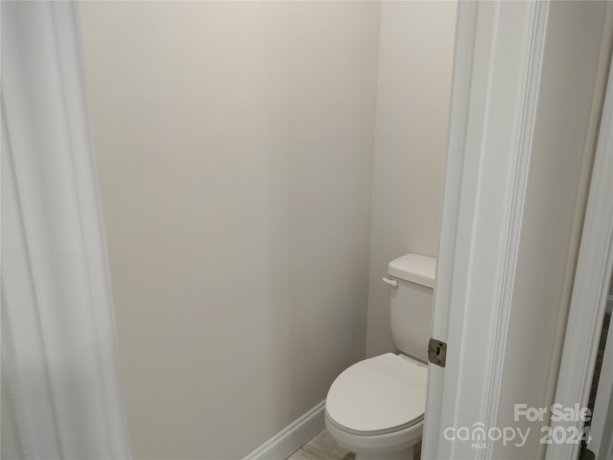 252 Hamrick Road, Unit 10 Cramerton, NC 28056 - Photo 23 of 37 a white toilet sitting next to a white wall