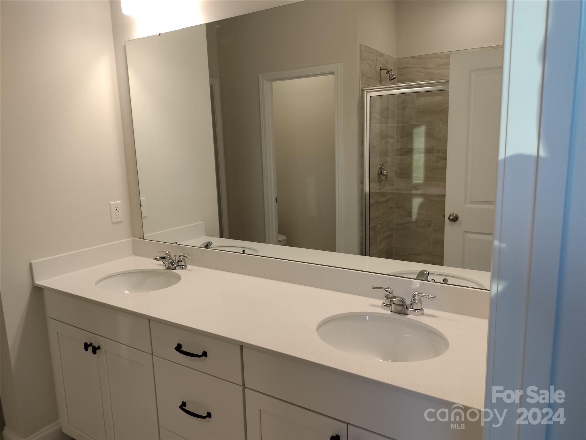 252 Hamrick Road, Unit 10 Cramerton, NC 28056 - Photo 24 of 37 a bathroom with a sink and a mirror