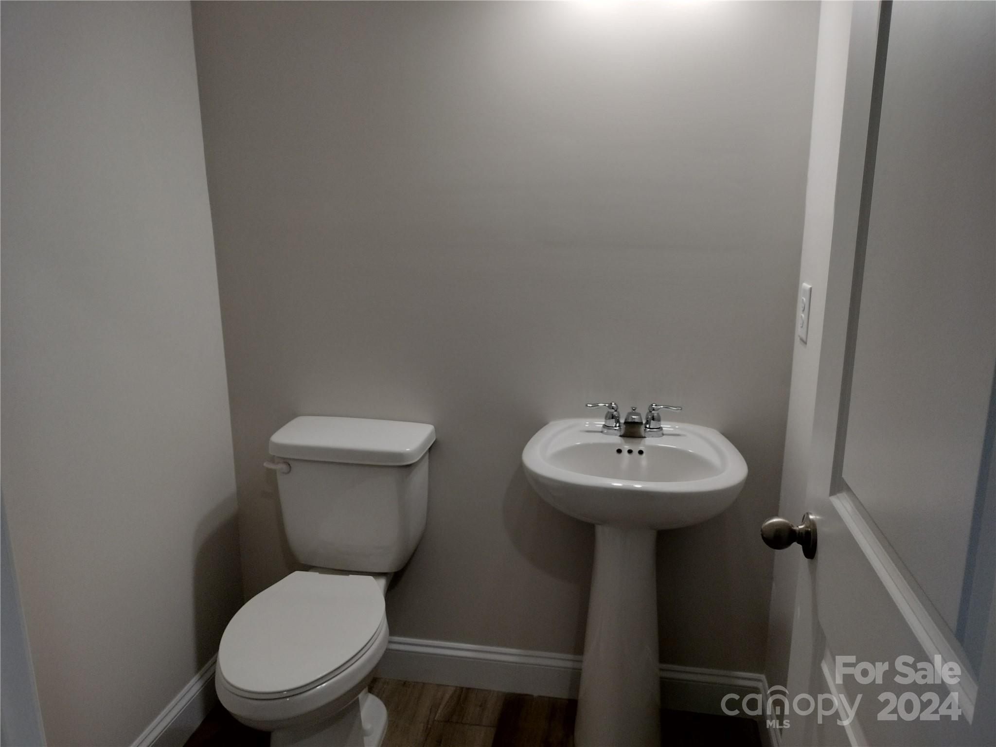 252 Hamrick Road, Unit 10 Cramerton, NC 28056 - Photo 25 of 37 a bathroom with a toilet a sink and a mirror