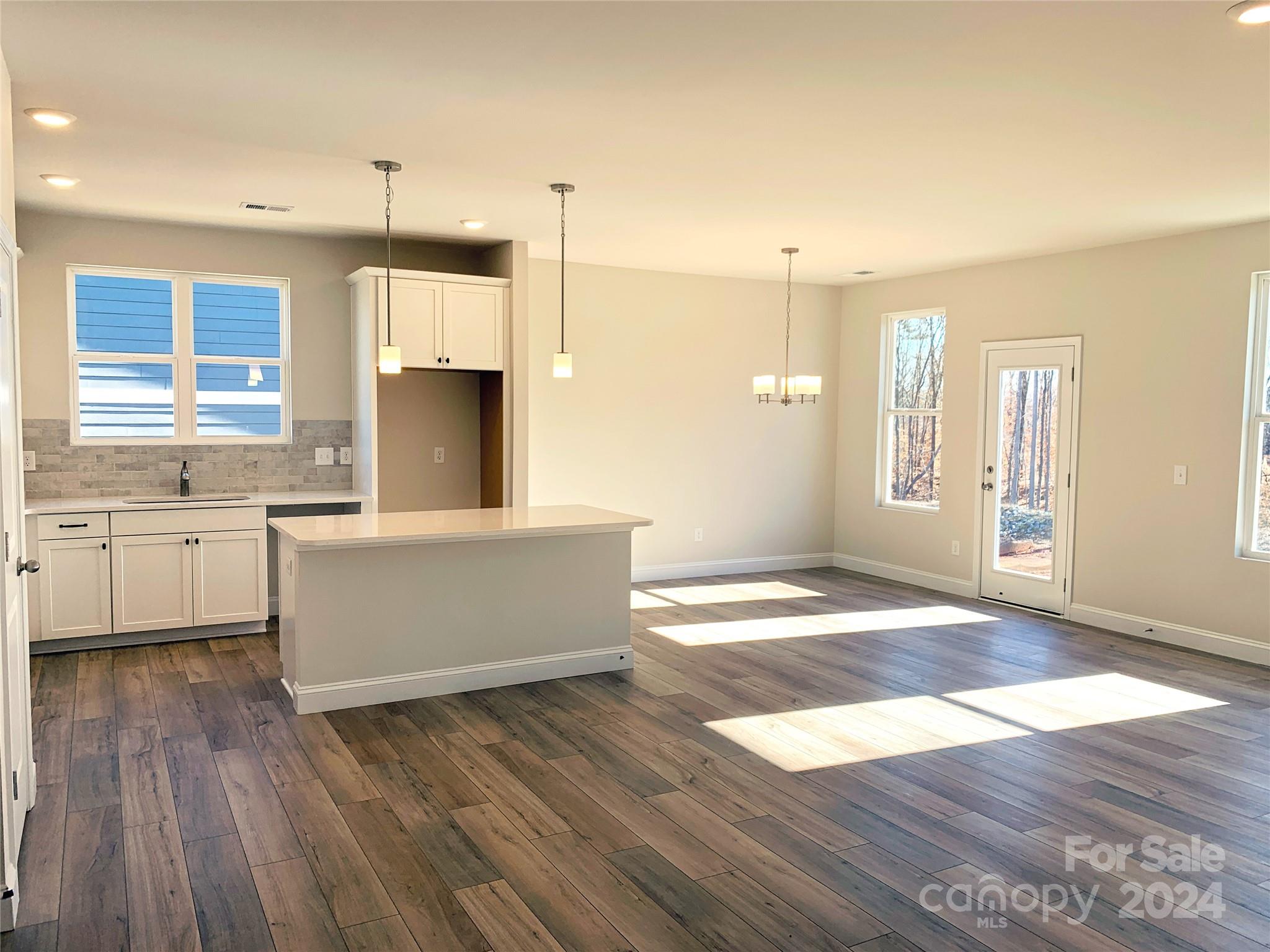 252 Hamrick Road, Unit 10 Cramerton, NC 28056 - Photo 30 of 37 a large kitchen with kitchen island a sink stainless steel appliances and cabinets