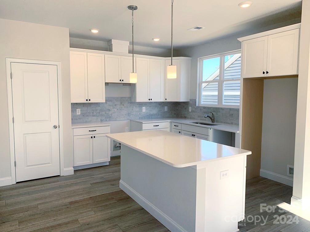 252 Hamrick Road, Unit 10 Cramerton, NC 28056 - Photo 33 of 37 a large kitchen with kitchen island granite countertop a sink a counter space stainless steel appliances and cabinets