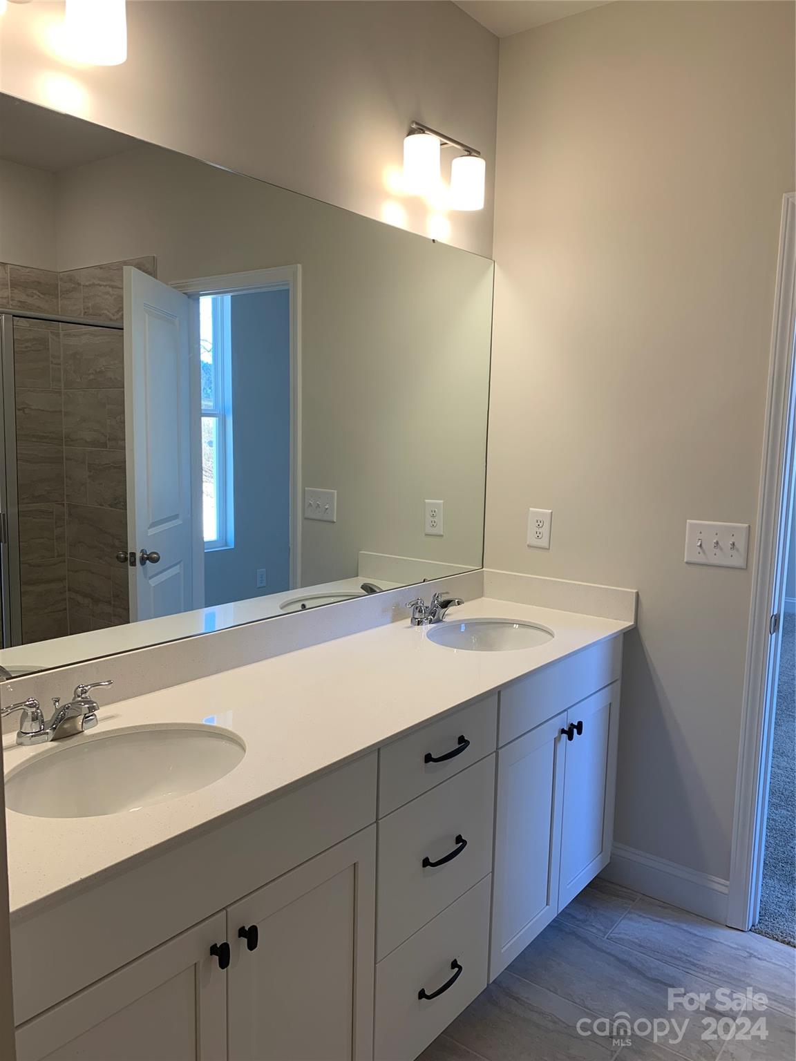 252 Hamrick Road, Unit 10 Cramerton, NC 28056 - Photo 36 of 37 a bathroom with a double vanity sink and a mirror