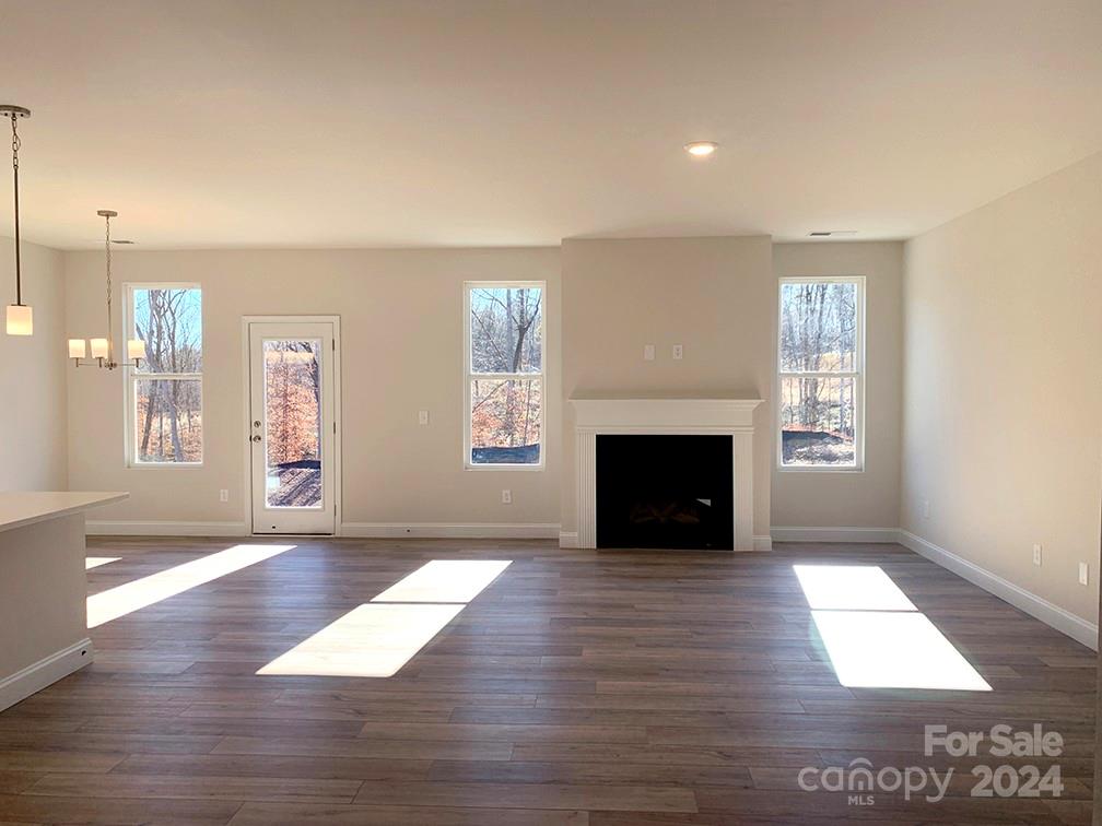 252 Hamrick Road, Unit 10 Cramerton, NC 28056 - Photo 37 of 37 an empty room with wooden floor and fireplace