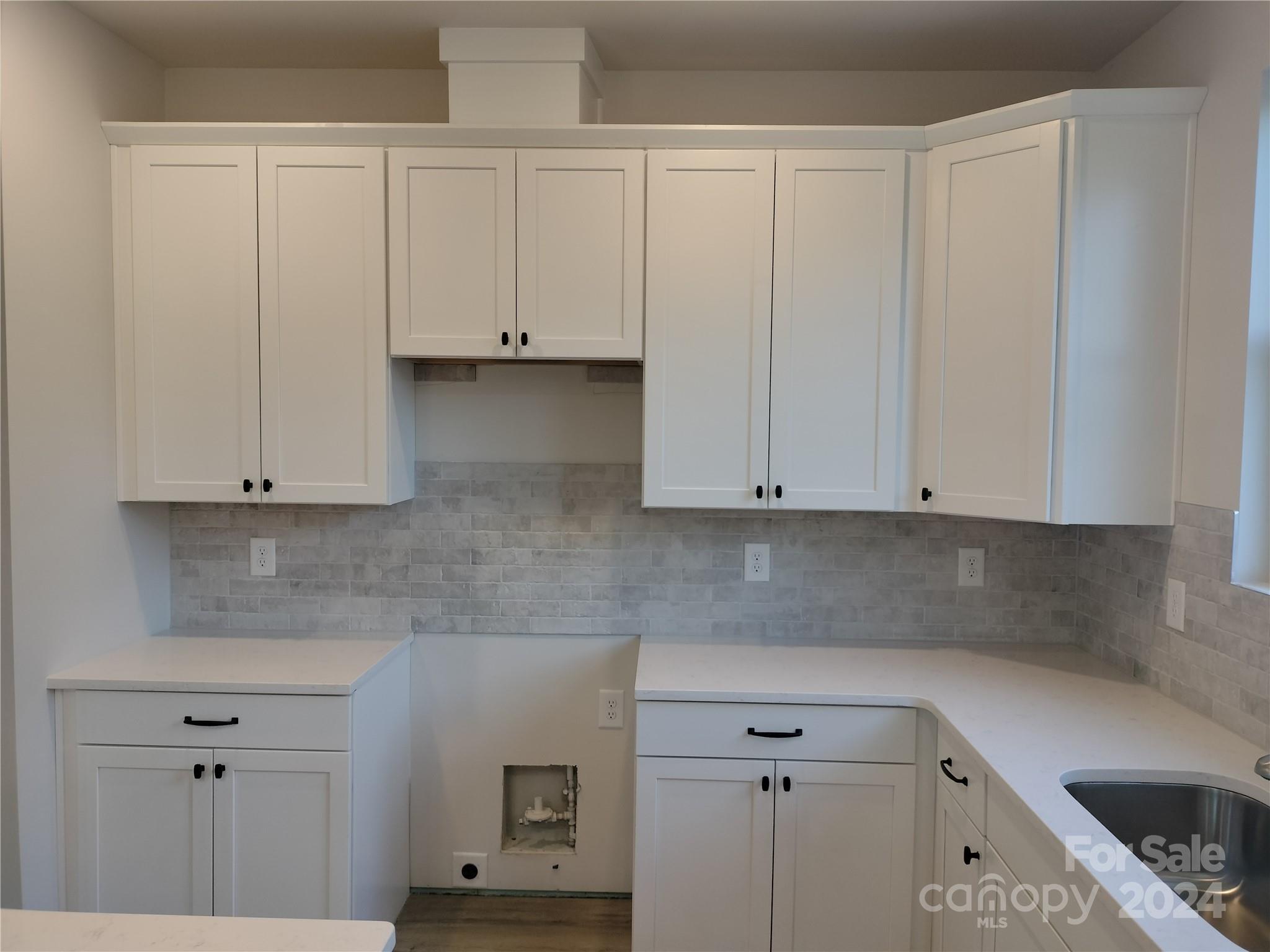 252 Hamrick Road, Unit 10 Cramerton, NC 28056 - Photo 9 of 37 a kitchen with white cabinets and a sink