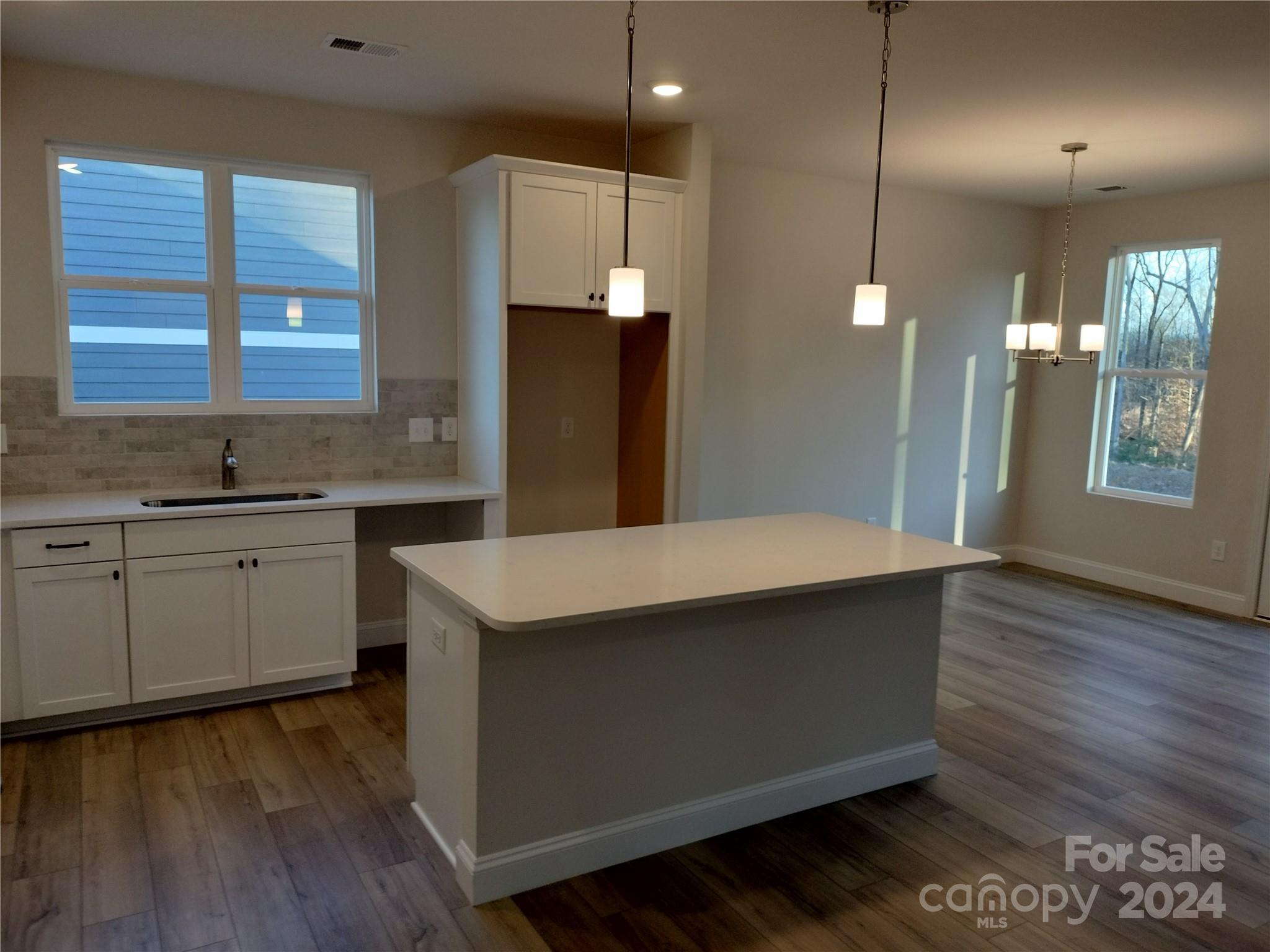 252 Hamrick Road, Unit 10 Cramerton, NC 28056 - Photo 10 of 37 a kitchen with kitchen island a sink stainless steel appliances and cabinets