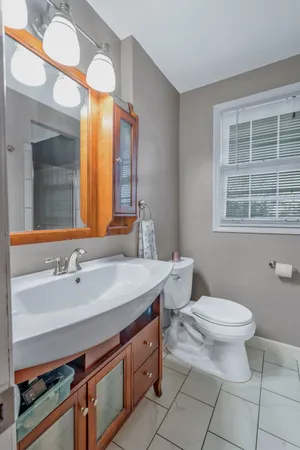 a bedroom with a chair and a flat screen tv