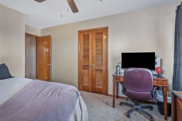 a bedroom with bed and a flat screen tv