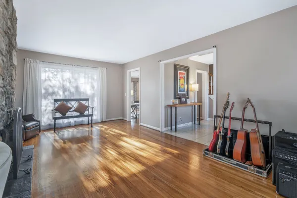 a view of a livingroom with wooden floor and furniture