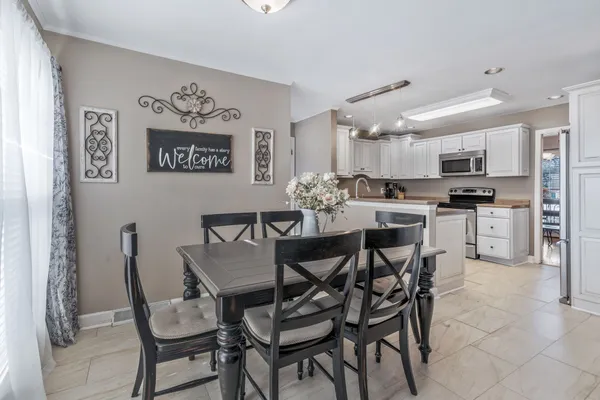 a view of a dining room and livingroom with furniture
