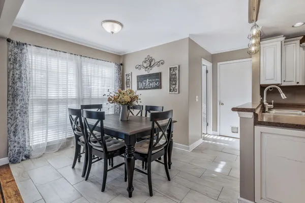 a view of a dining room with furniture wooden floor and a chandelier