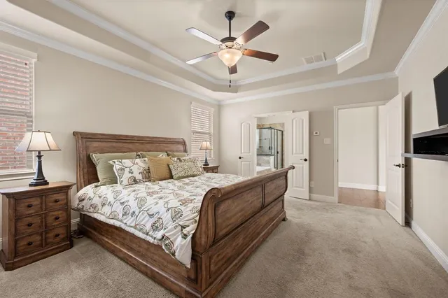 a bedroom with a bed and a ceiling fan