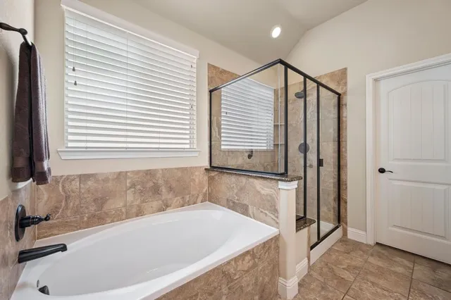 a bathroom with a bathtub and a window