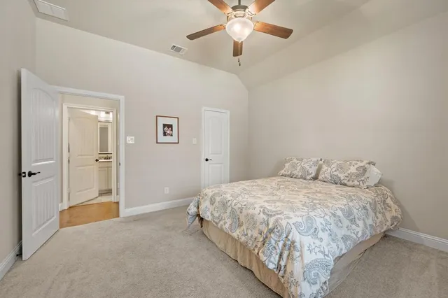 a bathroom with a granite countertop sink vanity mirror shower and a toilet