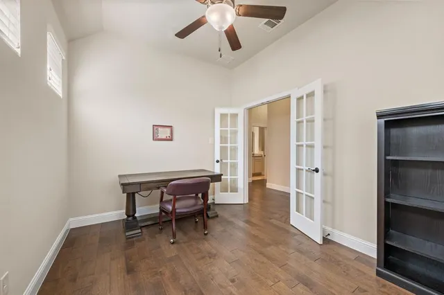 a view of a workspace with furniture and a window
