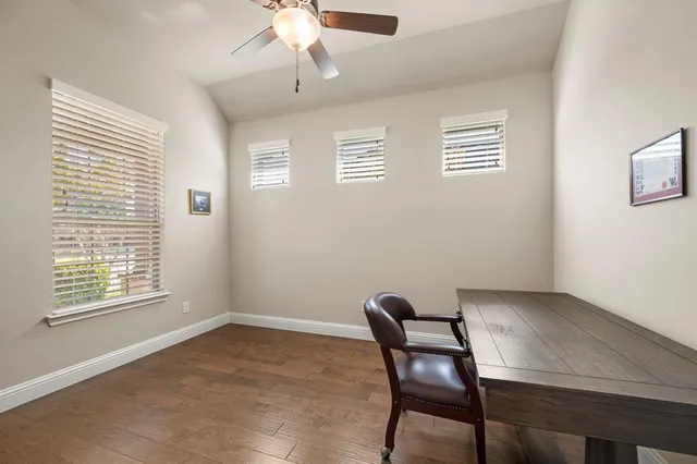 a view of a patio with table and chairs with wooden floor and fence