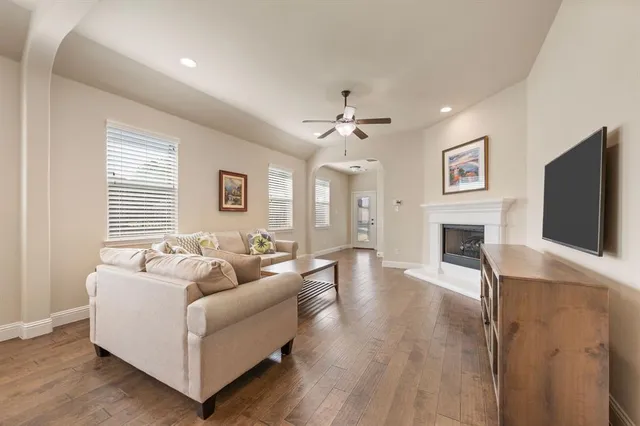 a living room with furniture fireplace and flat screen tv