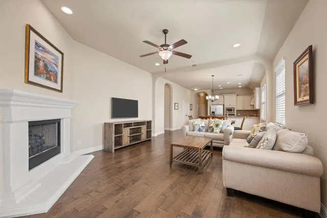 a living room with furniture kitchen view and a fireplace