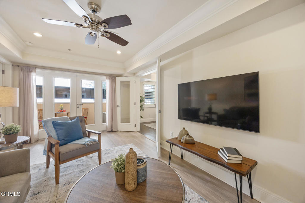 120 South Mentor Avenue, Unit 202 Pasadena, CA 91106 - Photo 16 of 40 a living room with furniture and a flat screen tv