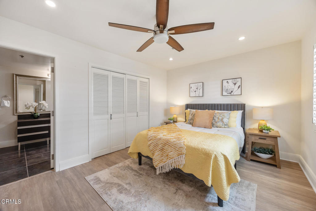 120 South Mentor Avenue, Unit 202 Pasadena, CA 91106 - Photo 18 of 40 a bedroom with a bed and a chandelier