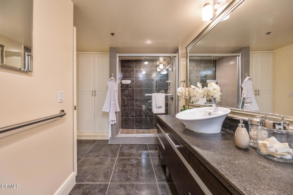 120 South Mentor Avenue, Unit 202 Pasadena, CA 91106 - Photo 22 of 40 a bathroom with a granite countertop sink a toilet and shower
