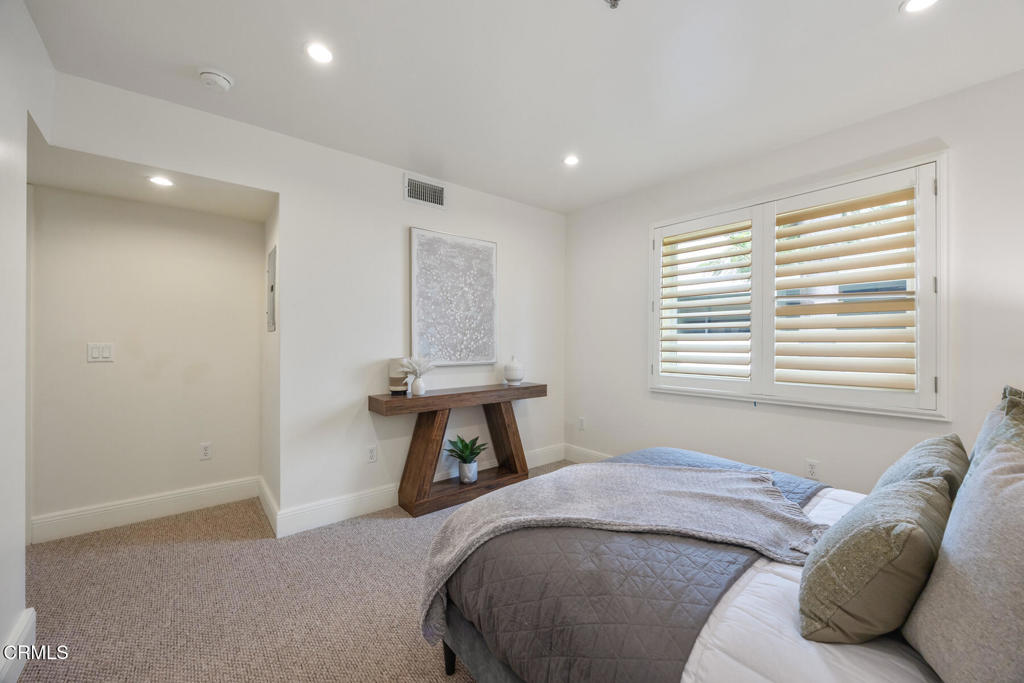 120 South Mentor Avenue, Unit 202 Pasadena, CA 91106 - Photo 30 of 40 a bedroom with a bed and a window