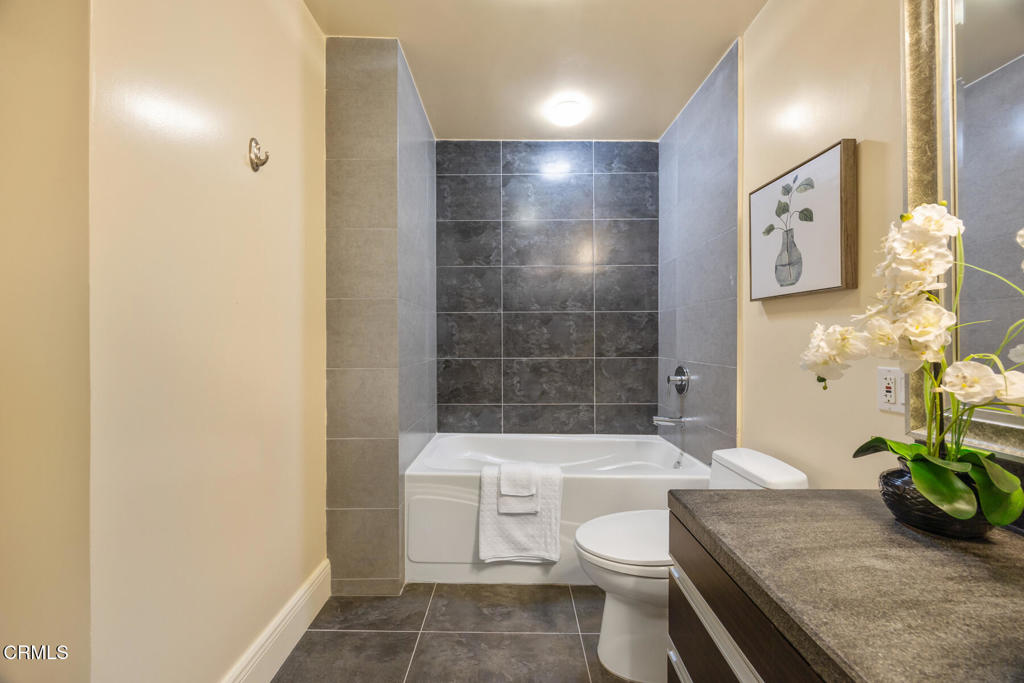 120 South Mentor Avenue, Unit 202 Pasadena, CA 91106 - Photo 32 of 40 a white toilet sitting next to a bathroom sink and tub