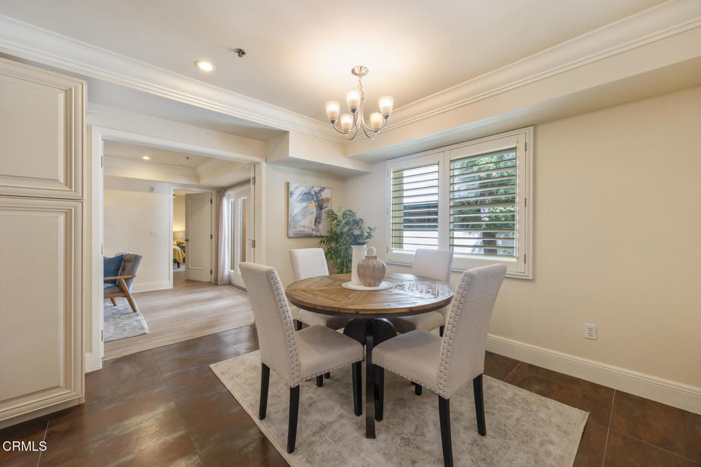 120 South Mentor Avenue, Unit 202 Pasadena, CA 91106 - Photo 8 of 40 a view of a dining room with furniture and a chandelier