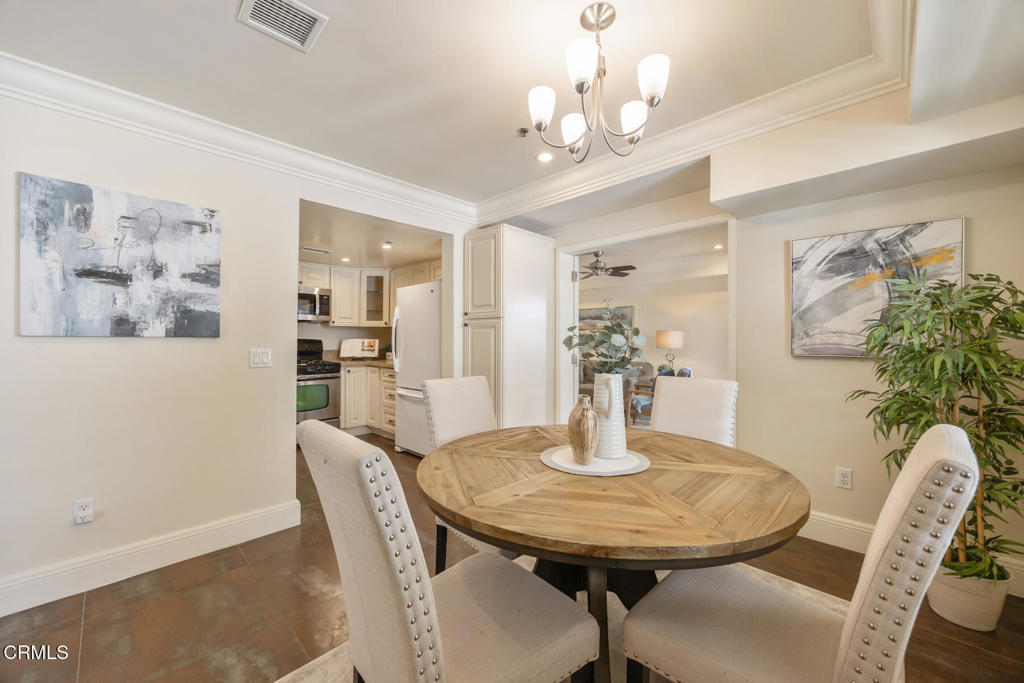 120 South Mentor Avenue, Unit 202 Pasadena, CA 91106 - Photo 9 of 40 a dining room with furniture and chandelier