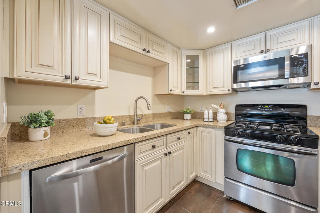 120 South Mentor Avenue, Unit 202 Pasadena, CA 91106 - Photo 10 of 40 a kitchen with appliances a sink and cabinets