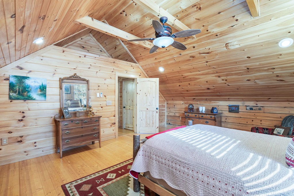 488 Smith Road Brasstown, NC 28902 - Photo 12 of 42 a bedroom with a bed and wooden floors