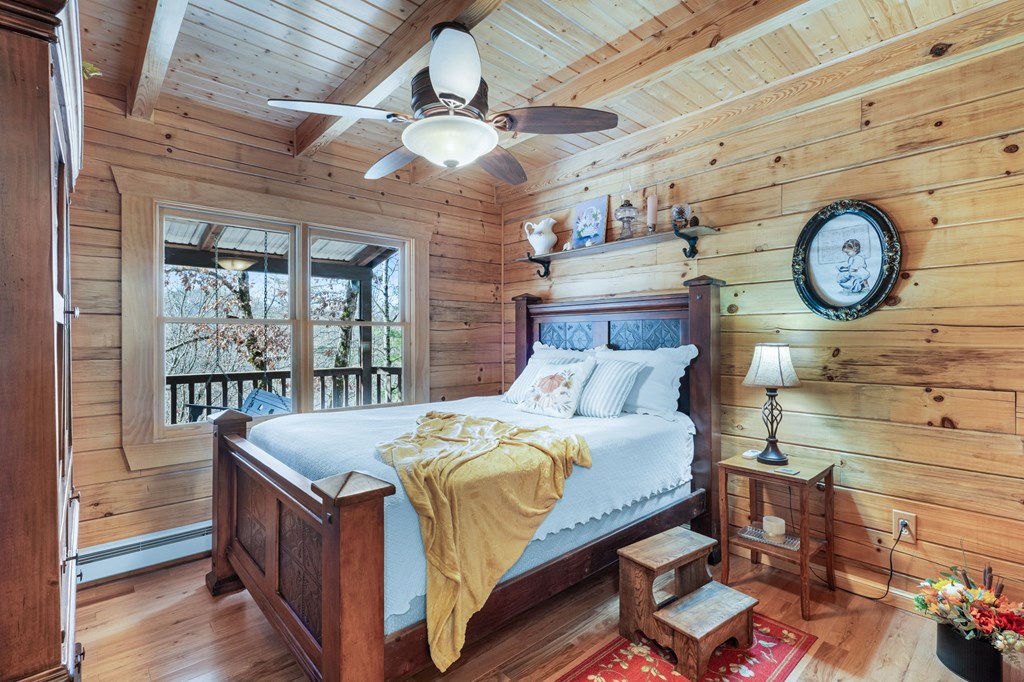 488 Smith Road Brasstown, NC 28902 - Photo 13 of 42 a bed room with a bed and a clock