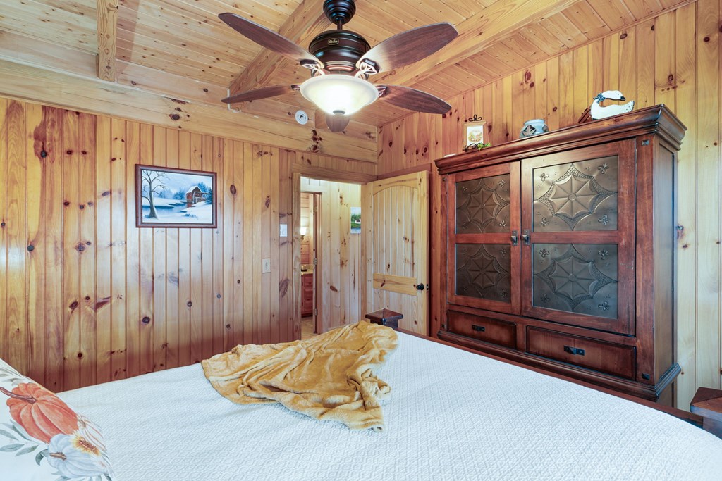 488 Smith Road Brasstown, NC 28902 - Photo 14 of 42 a bedroom with a bed and window