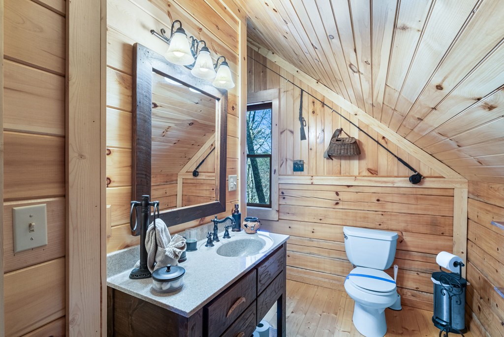 488 Smith Road Brasstown, NC 28902 - Photo 15 of 42 a bathroom with a toilet sink and mirror