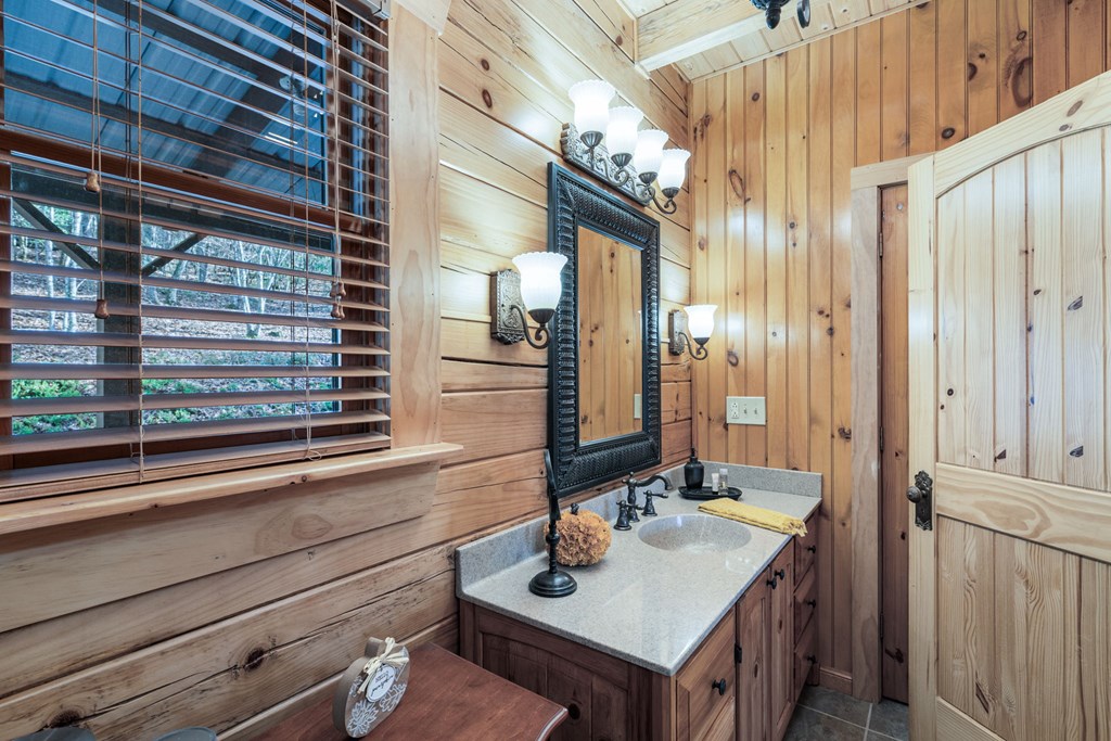 488 Smith Road Brasstown, NC 28902 - Photo 17 of 42 a bathroom with a sink a mirror and shower