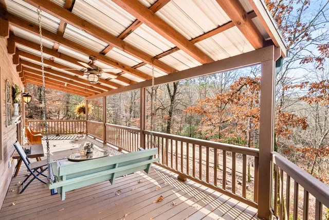 a view of a balcony with wooden fence and floor