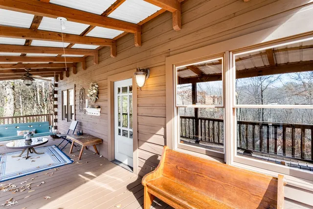 a view of a porch with furniture and a yard