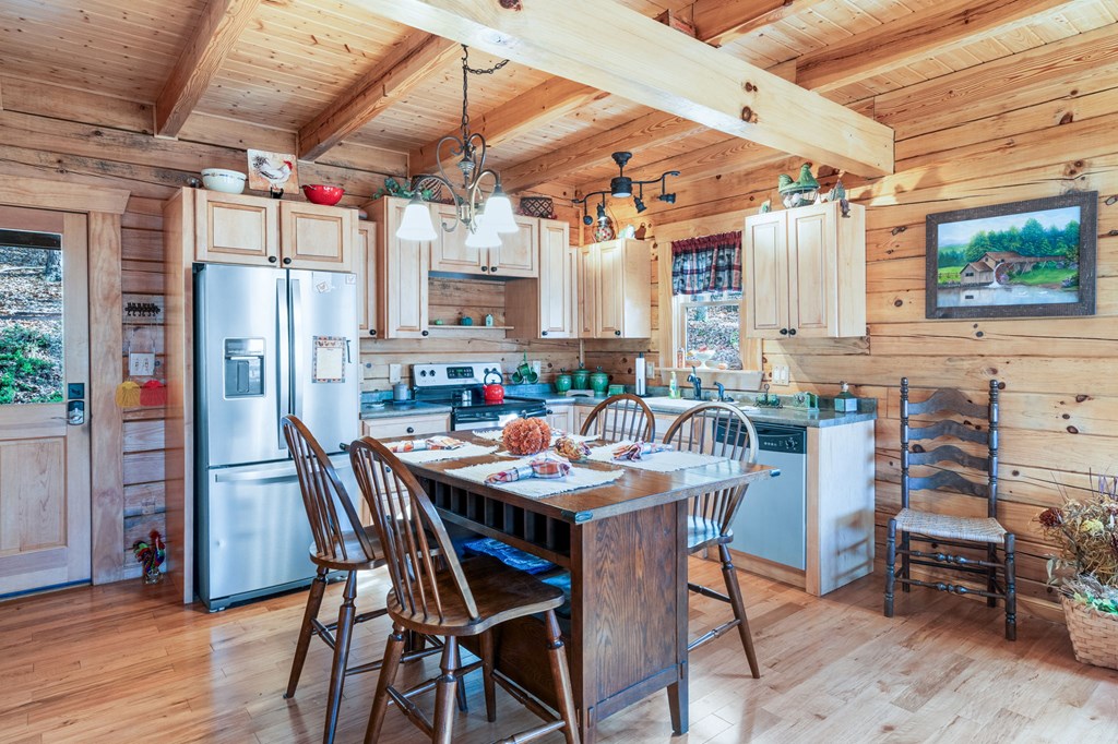 488 Smith Road Brasstown, NC 28902 - Photo 3 of 42 a view of a dining area with furniture window and wooden floor