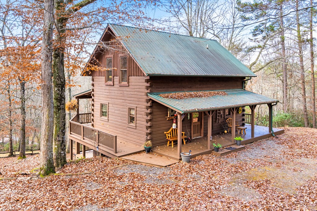 488 Smith Road Brasstown, NC 28902 - Photo 31 of 42 a view of a house with a wooden fence and a large tree