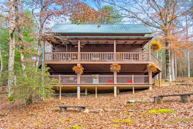 a backyard of a house with wooden floor and fence
