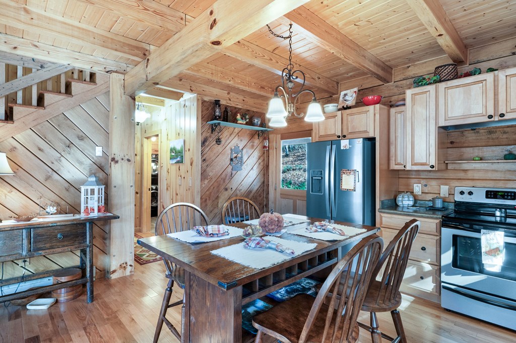 488 Smith Road Brasstown, NC 28902 - Photo 6 of 42 a view of a dining table and chairs in a patio