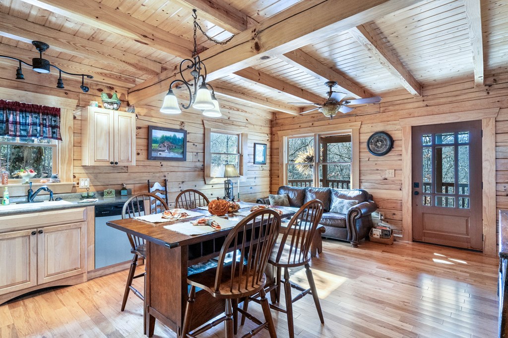 488 Smith Road Brasstown, NC 28902 - Photo 8 of 42 a view of a dining room with furniture window and wooden floor