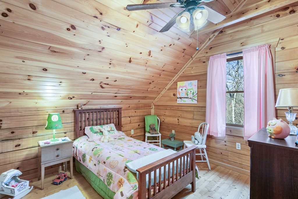 488 Smith Road Brasstown, NC 28902 - Photo 9 of 42 a bedroom with a bed and a window