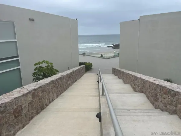 a kitchen with stainless steel appliances kitchen island granite countertop furniture and a refrigerator