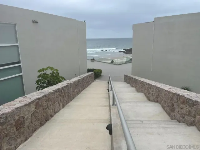 a kitchen with stainless steel appliances kitchen island granite countertop furniture and a refrigerator