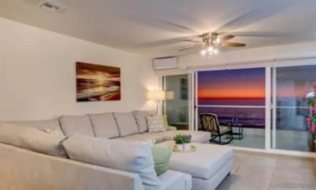 a spacious bedroom with a large bed and a chandelier