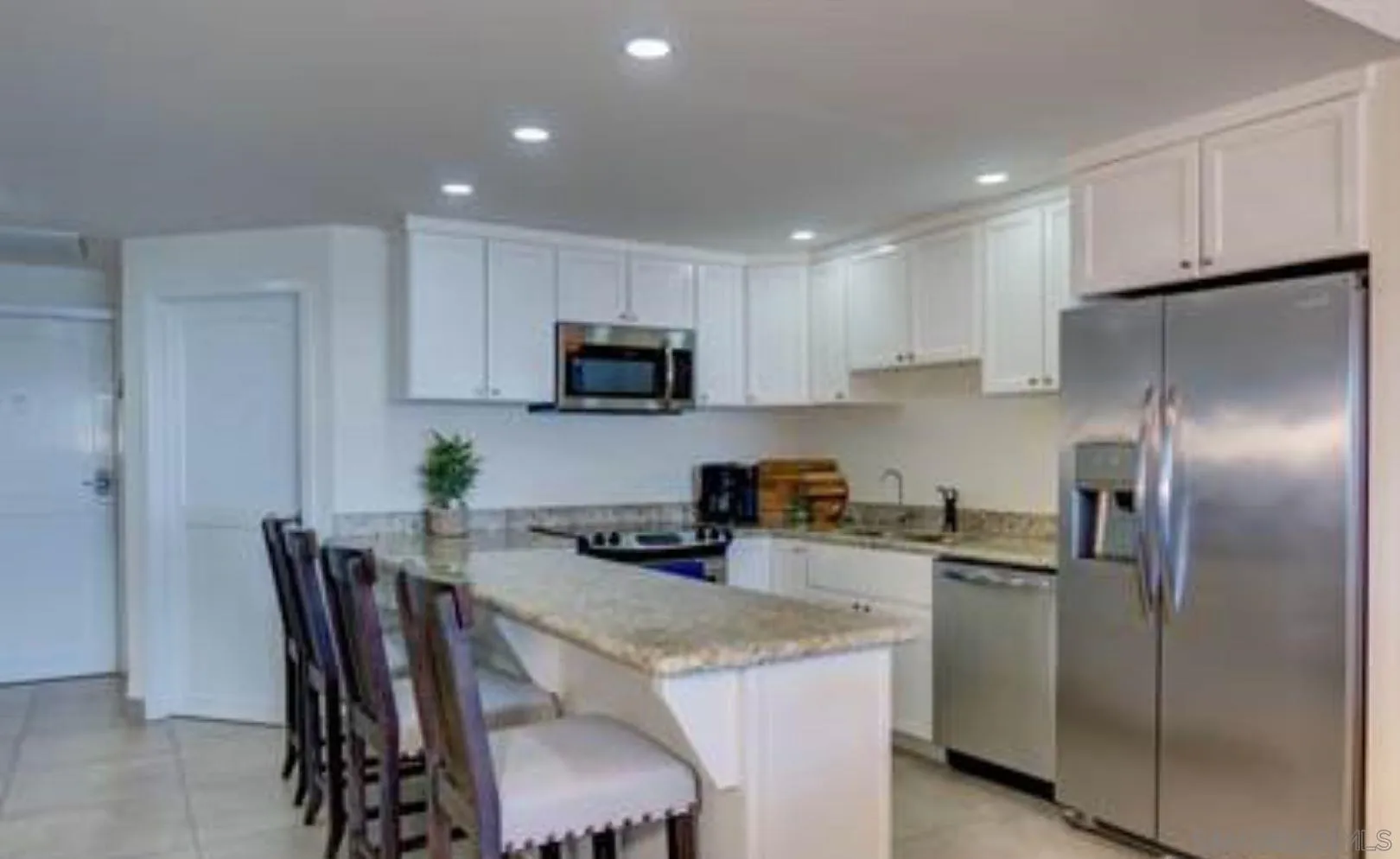 115 Carretera Libre Tijuana O'Neals, CA 93645 - Photo 45 of 62 a kitchen with stainless steel appliances granite countertop a refrigerator a stove a sink a dining table and chairs