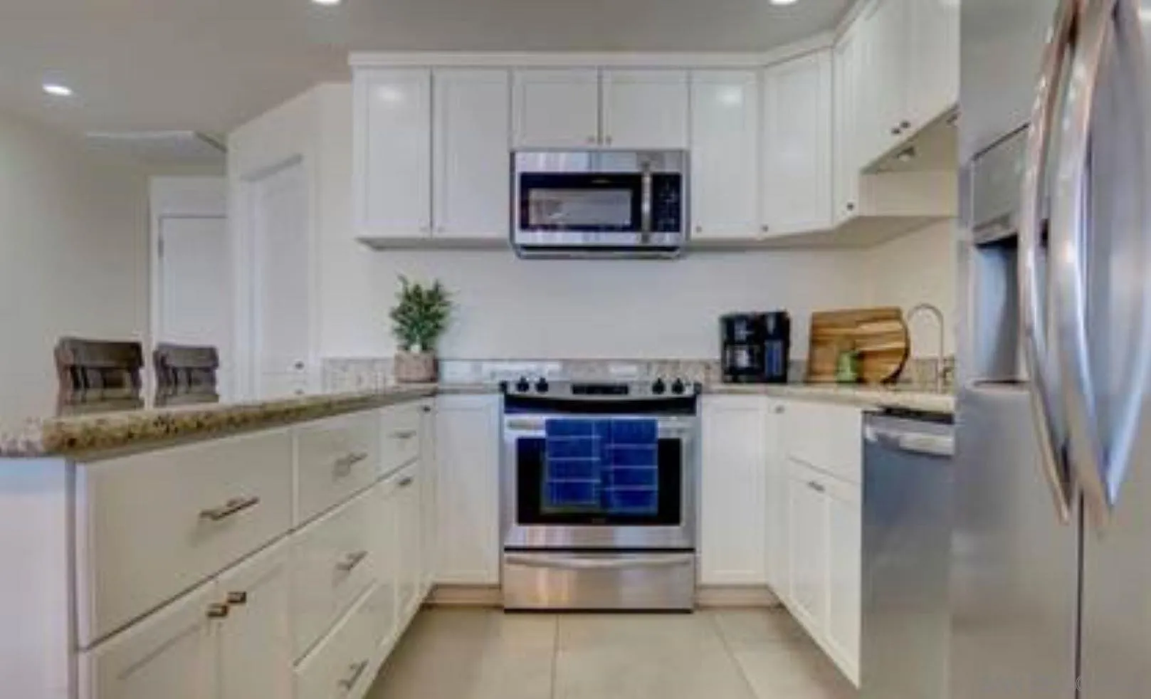115 Carretera Libre Tijuana O'Neals, CA 93645 - Photo 47 of 62 a kitchen with granite countertop a refrigerator and a stove top oven