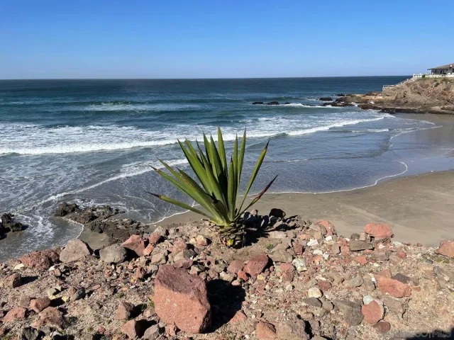 a blue and white umbrella sitting in the ocean